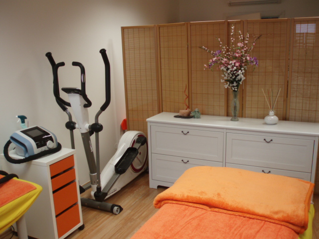 Treatment room with BTL device, dresser with flowers and bamboo screen